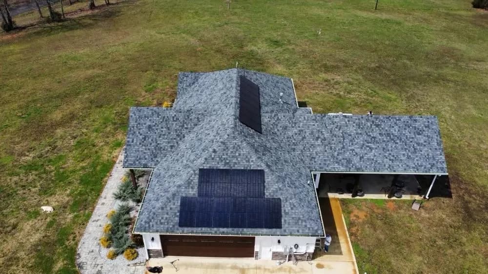 Aerial view of solar panels installed across a residential roof